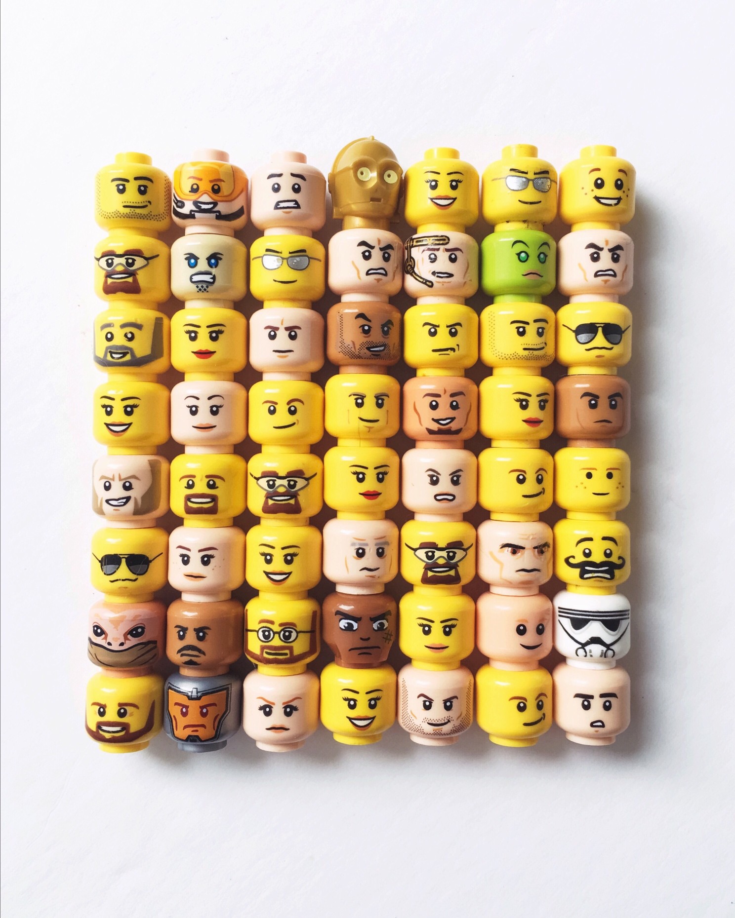 Layers Of Stacked Lego Toy Block Heads With Assorted Emotions On A White Background T20 6W90k6