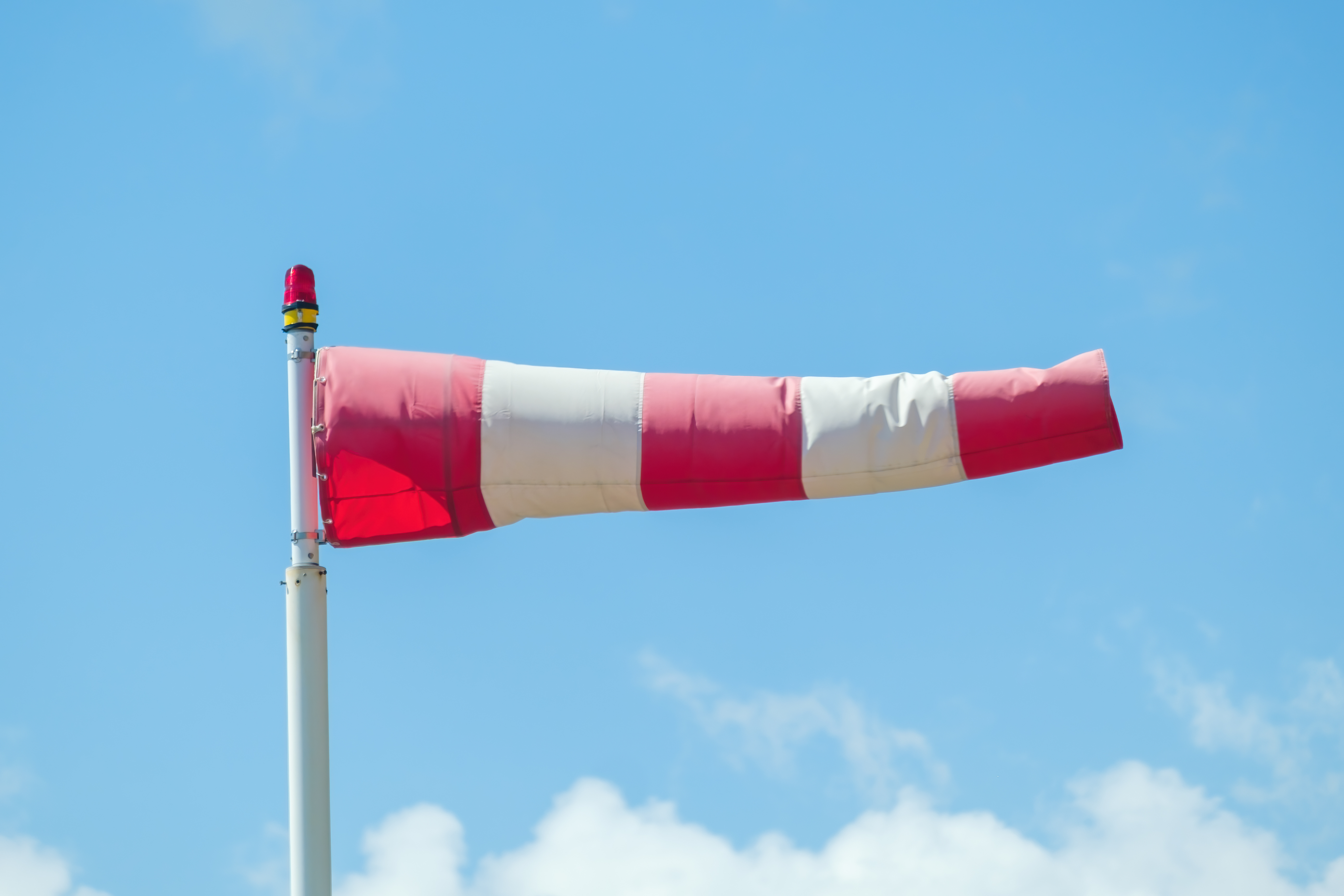 Windsock Against A Blue Sky And Clouds Showed The 2022 02 14 16 32 48 Utc